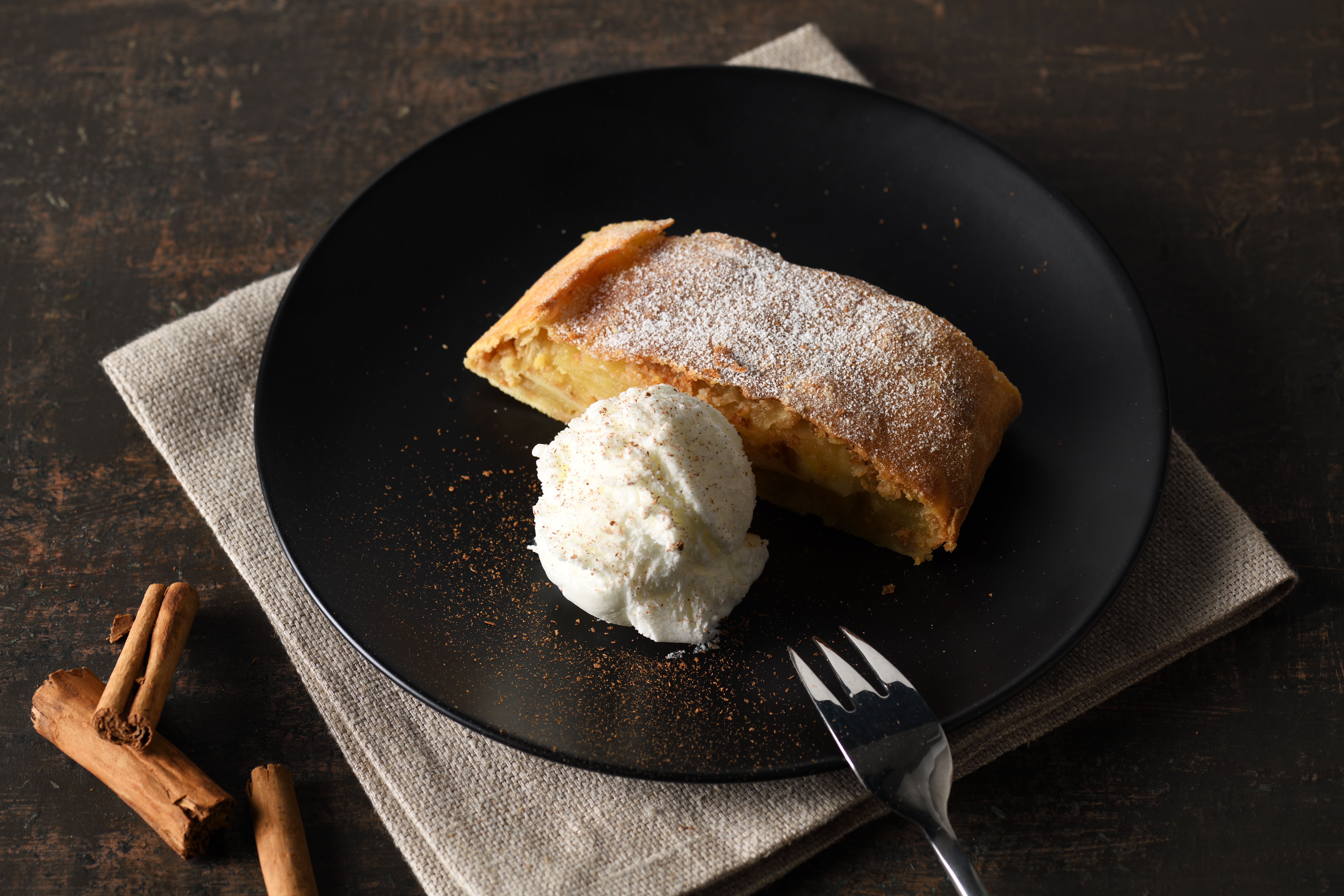 plate with apple strudel and ice cream