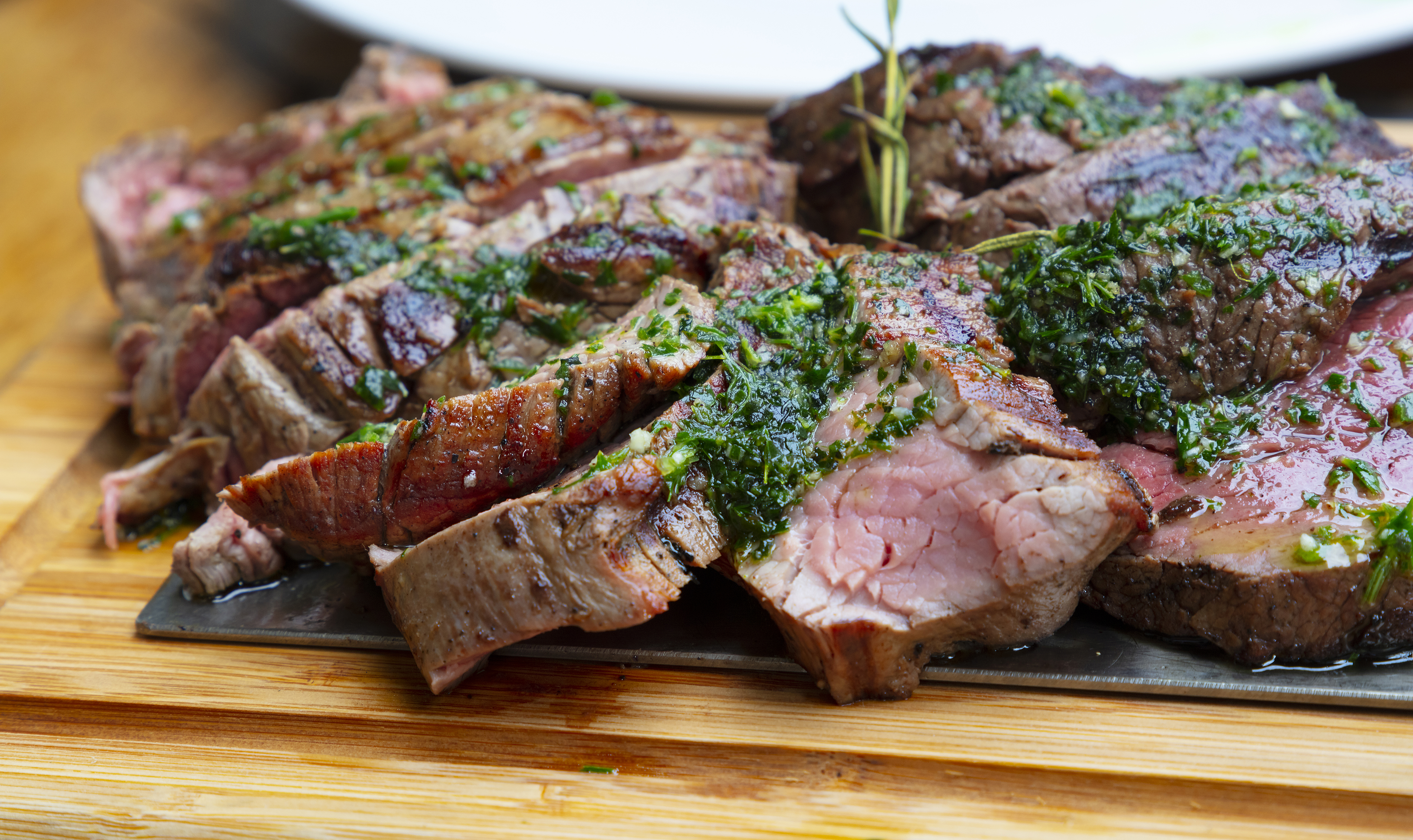portion of grilled beef chateaubriand with herbs